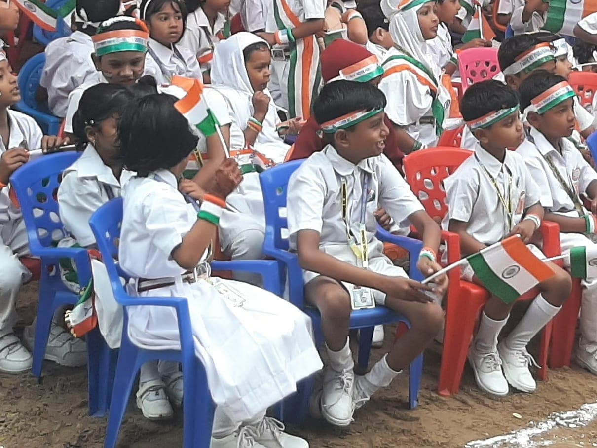 Manara Academy students holding the national flag at the school's Annual Function